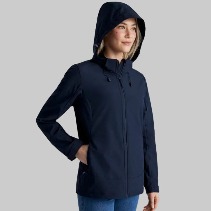 Woman wearing a navy blue hooded jacket on a light gray background